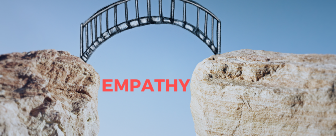 two large boulders with large gap in between with the word "empathy" under a bridge